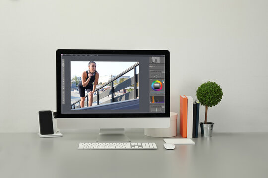 Designer's workplace. Computer with photo editor application on table - Powered by Adobe