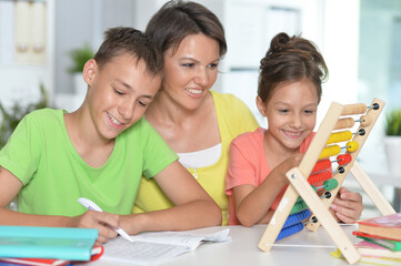 mother helping  children with homework