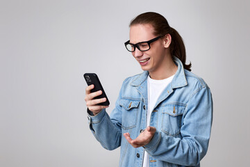 young man in glasses using smart phone