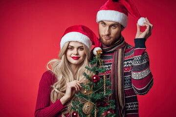 man and woman in New Year's clothes celebrate Christmas together