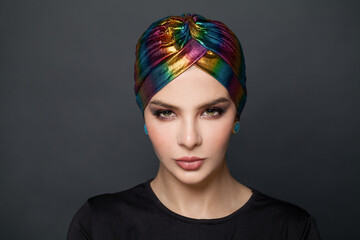 Glamour woman in a turban on black background