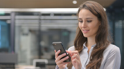 Fototapeta na wymiar Portrait of Young Businesswoman using Smartphone