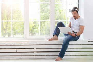 handsome young man with laptop at home