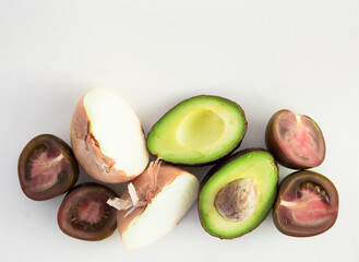 vegetables black tomatoes, avocado and onions on white background