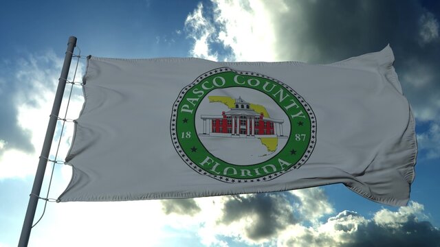 Pasco flag, county of the state of Florida, United States of America waving at wind in blue sky. 3d rendering