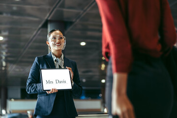 Chauffeur with a sign at airport arrival gate