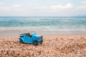 Vintage miniature old blue car on summer background