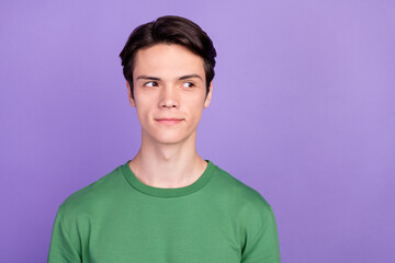 Photo of young handsome guy happy positive smile curious dream think look empty space isolated over violet color background