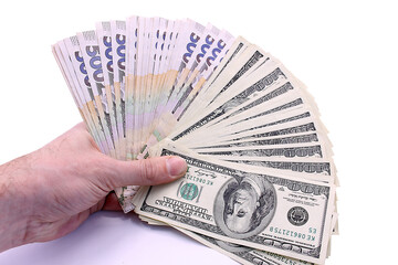 Banknotes of Ukraine and the USA in denominations of five hundred hryvnia and 100 dollars in hand