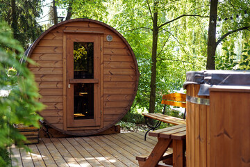 outdoor wooden barrel sauna in the garden - 447503565