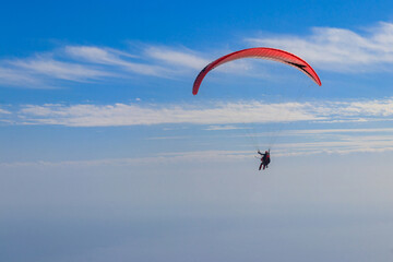Paragliders in blue sky. Concept of active lifestyle and extreme sport adventure