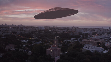 Flying saucer over Tel aviv city at sunset with church, aerial 
drone view from Israel ufo invasion...