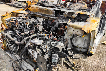 Burned-out car after arson accident. Melted plastic in a fire.