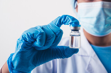 Closeup vial of covid-19 vaccine in hand of professional scientist or doctor in laboratory for...