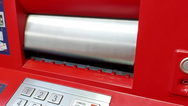 A man puts 100 dollars in an ATM bill acceptor. Payment for services and goods, close-up