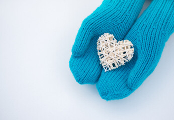 Female hands in mittens with heart, close-up