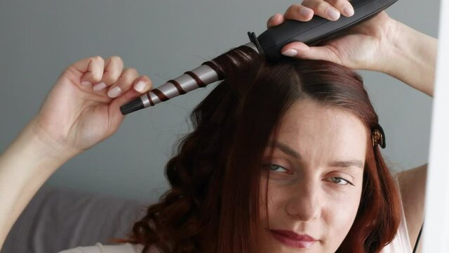 Smiling woman hairstyle wavy curls. Hair curler glyph icon. Professional hair care.
