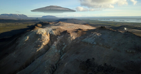 Flying Saucer Over Volcanic Geyser Mountain, aerial
drone view from Iceland Volcano landscape
