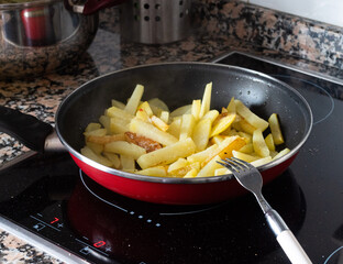 French fries being cooked in a pan