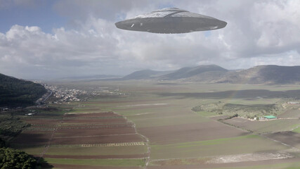 Alien ufo flying saucer over Canyon and mountains, aerial
drone view from Golan Heights Israel,...