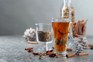 Herbal tea with spices on a grey background.
