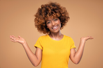 Beauty portrait of young attractive afro woman with perfect smile and delicate glamour makeup with yellow eyeliner.