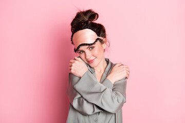 Photo of pretty positive girl arms hugging shoulder look camera have good mood isolated on pink color background