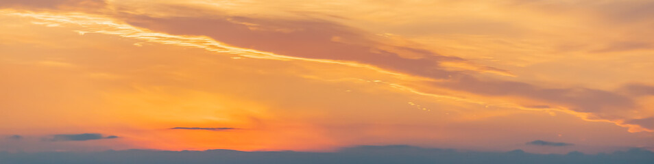 Fiery sunset, colorful clouds in the sky. Panorama