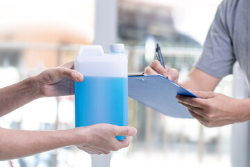 Asia women receive Alcohols spray with Post man delivery and check list in job protection and stay at home concept