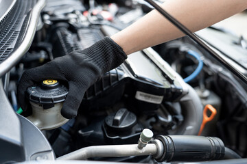 Hand of Technician checking brake fluid  in engine room maintenance and basic service concept of...