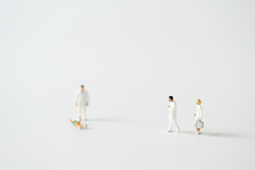Miniature people Doctor and Nurse emergency medical team on white background using for digital...