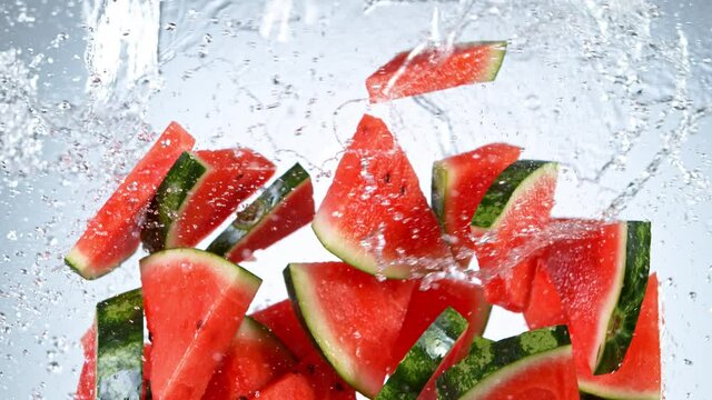 Super slow motion of sliced water melon with water splash flying in the air. Filmed on high speed cinema camera, 1000 fps.