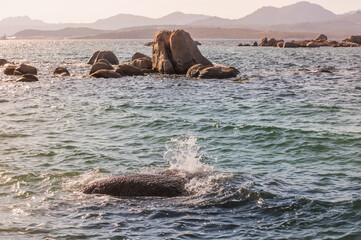 beautiful sea at sunset with rocks and mountains in the background.Sardinia