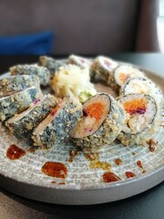 fried rolls in a circle on a round plate. top view. delicious Japanese food.