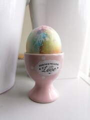 easter painted egg on a pink stand