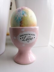 easter painted egg on a pink stand