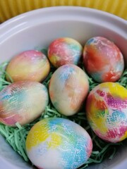 easter painted eggs on a white plate