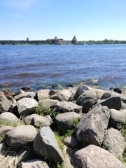 big cobblestones on the river bank on a sunny summer day