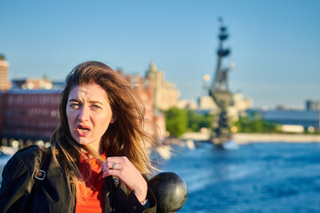 Fototapeta premium Portrait of a young woman is complaining about something on the street
