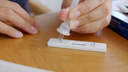 Close-up face of young adult asia woman people use auto PCR cotton self cure kit from hospital clinic service by telehealth telemedicine call support in cold flu virus health care isolate at home.