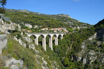 Fototapeta premium Road from Nice to Italy. View from the Moenne Kornice scenic road to the viaduct (stone Arch bridge) near the Eze village.