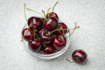 Glass bowl with fresh red ripe juicy cherries  