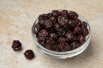 Glass bowl with sweet red dried cherries close up 