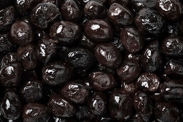 Preserved Moroccan black breakfast olives close up full frame as a background
