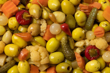 Mixture of preserved olives and vegetables close up full frame for a snack 