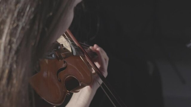 a string quartet plays a classical symphony in a dark hall