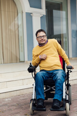 Fototapeta na wymiar a man with disabilities in a wheelchair enjoys life
