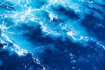 Waves and blue water as a background. View at the ocean surface. Natural summer seascape. Water background. Abstract blue ocean background.