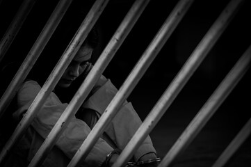 Portrait of women desperate to catch the iron prison,prisoner concept,thailand people,Hope to be free,If the violate the law would be arrested and jailed.