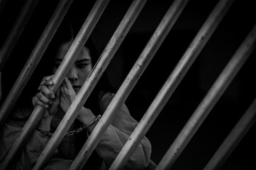 Portrait of women desperate to catch the iron prison,prisoner concept,thailand people,Hope to be...